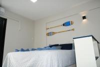 a bedroom with a bed with baseball bats on the wall at Flat Sirena - São Vicente in São Vicente