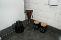 a counter with two cups and a vase on it at Flat Sirena - São Vicente in São Vicente
