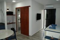 a room with a room with a table and a door at Flat Sirena - São Vicente in São Vicente