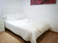 A bed or beds in a room at Apartamentos Day Madrid ILDEFONSO Centro Gran Via Sol Malasaña