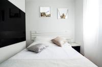 A bed or beds in a room at Apartamentos Day Madrid ILDEFONSO Centro Gran Via Sol Malasaña