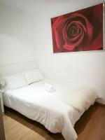 A bed or beds in a room at Apartamentos Day Madrid ILDEFONSO Centro Gran Via Sol Malasaña