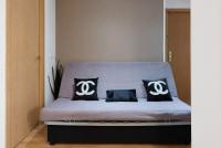 A bed or beds in a room at Apartamentos Day Madrid ILDEFONSO Centro Gran Via Sol Malasaña
