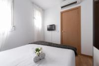A bed or beds in a room at Apartamentos Day Madrid ILDEFONSO Centro Gran Via Sol Malasaña
