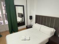 A bed or beds in a room at Apartamentos Day Madrid SANTO DOMINGO Centro Gran Via Sol Malasaña