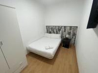 A bed or beds in a room at Apartamentos Day Madrid SANTO DOMINGO Centro Gran Via Sol Malasaña