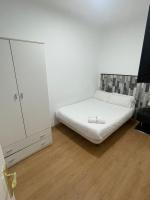 A bed or beds in a room at Apartamentos Day Madrid SANTO DOMINGO Centro Gran Via Sol Malasaña