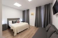 A bed or beds in a room at Apartamentos Day Madrid SANTO DOMINGO Centro Gran Via Sol Malasaña
