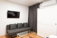 A television and/or entertainment centre at Apartamentos Day Madrid SANTO DOMINGO Centro Gran Via Sol Malasaña