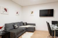 A television and/or entertainment centre at Apartamentos Day Madrid SANTO DOMINGO Centro Gran Via Sol Malasaña