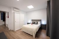 A bed or beds in a room at Apartamentos Day Madrid SANTO DOMINGO Centro Gran Via Sol Malasaña
