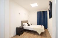 A bed or beds in a room at Apartamentos Day Madrid SANTO DOMINGO Centro Gran Via Sol Malasaña