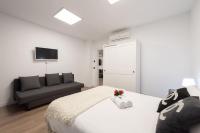 A television and/or entertainment centre at Apartamentos Day Madrid SANTO DOMINGO Centro Gran Via Sol Malasaña