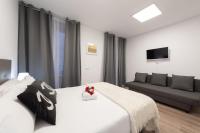 A bed or beds in a room at Apartamentos Day Madrid SANTO DOMINGO Centro Gran Via Sol Malasaña