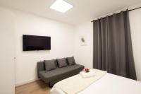 A bed or beds in a room at Apartamentos Day Madrid SANTO DOMINGO Centro Gran Via Sol Malasaña
