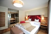 Postel nebo postele na pokoji v ubytování Hotel Dorfstadl