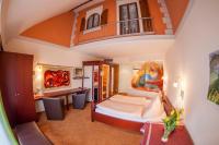 a bedroom with a large bed and a balcony at Bavaria Lifestyle Hotel in Altötting