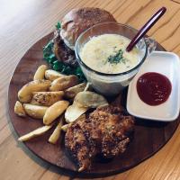 a plate of food with a sandwich and dip and potatoes at LOGINNtarassoログインタラソ沖永良部島 in Wadomari