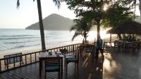 a person walking on a deck next to the beach at PingChan Koh Phangan Beachfront Resort in Thong Nai Pan Yai