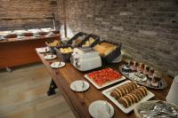 a table with a buffet of food on it at Wilson Palace by LOFT in Bratislava