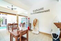a restaurant with a table and a surfboard on the wall at Balian Paradise Hotel in Selemadeg