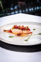 a piece of food on a white plate on a table at Hotel Milagros Golf in Mogro