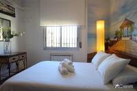 A bed or beds in a room at Villa Charma with private pool and Air conditioning close to sitges in peaceful location