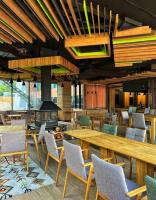 a lobby with tables and chairs and a fireplace at Charmy mountain suite in hotel Phoenix in SJJ