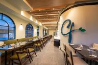 バンガロールにあるThe Lofts at Central Pointのテーブルと椅子が備わるレストラン