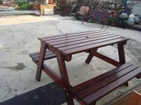 a wooden picnic table sitting next to a bench at Fu Yuan B&amp;B in Magong