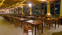 a row of tables and chairs in a restaurant at Grand Sunshine Resort & Convention in Bandung