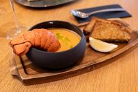 un plato con un tazón de sopa y un poco de pan en Fonnental Design Hotel Tallinn, en Tallin