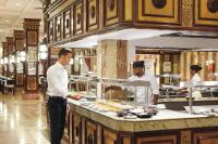 two chefs preparing food in a restaurant kitchen at Hotel Riu Funana - All Inclusive in Santa Maria