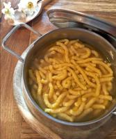 a pot of food with noodles in it on a table at B & B La Mela in Darfo