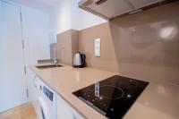 A kitchen or kitchenette at Atico duplex con Barbacoa y Terraza en Barri Port Maritim