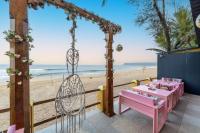 a table and a swing at the beach at The Rose Goa Beach Resort in Agonda
