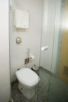 a bathroom with a toilet and a glass shower door at Flat Casa Mauá in Rio de Janeiro