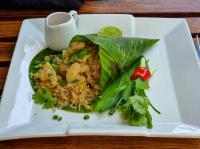 a plate of food with shrimp and rice on a table at Stellars Samed Resort in Ko Samed