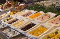 a buffet of different types of food in white trays at Maritim Hotel Stuttgart in Stuttgart
