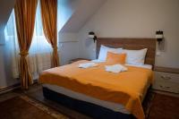 a bedroom with a large bed with two towels on it at Hotel Pepa in Divčibare