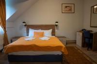 a bedroom with a bed with two towels on it at Hotel Pepa in Divčibare