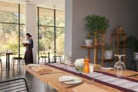 ティンプーにあるZhiwaling Ascentのテーブル付き部屋に立つ女性