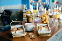 two baskets of bread on a table with plates at The Sea-Cret Garden Hua Hin in Hua Hin
