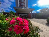 a bunch of pink flowers in front of a hotel at SKYHOTEL Merseburg in Merseburg