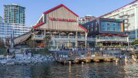 un edificio junto a una masa de agua con edificios en Seaside Hotel North Vancouver, en North Vancouver