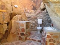 a stone bathroom with a toilet and a sink at Hais Ra Tented Campsite in Khorixas