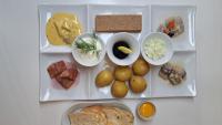 a white tray filled with different types of food at Évika boutique hotel in Eskilsby