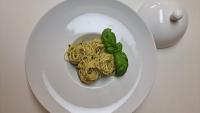 a white plate with pasta and basil on it at Évika boutique hotel in Eskilsby