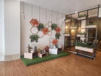 a room with plants on a wall with a table at Grand Serpong Hotel in Panunggangah