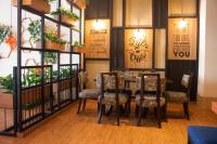 a restaurant with a table and chairs in a room at Grand Serpong Hotel in Panunggangah